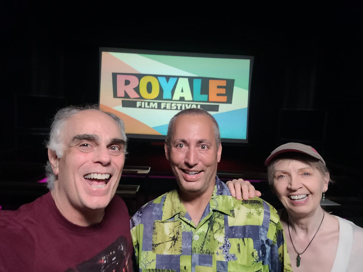 Los Angeles filmmakers Robert DiTillio (left) and Christine DiTillio (right) pose with festival host Danny Hercules (center) at the 3rd annual Royale Film Festival before showing their short, (Not So) Easy to Scare. (Photo by Robert DiTillio.)